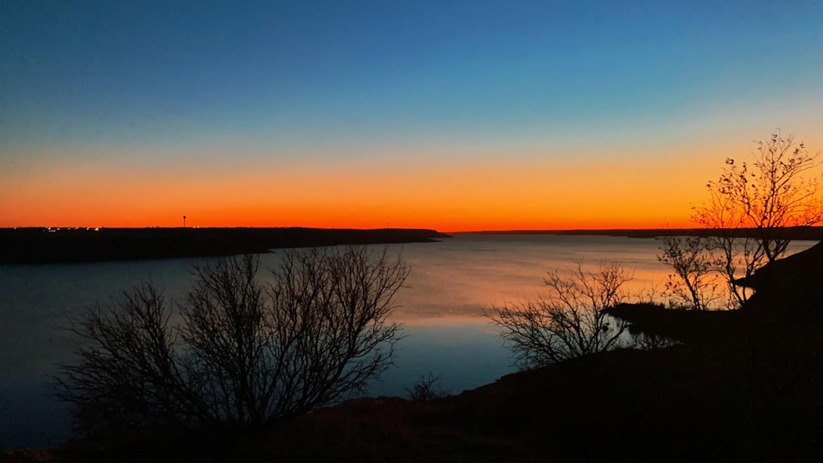 Sunset at Lake Meredith with colors of yellow, blue, and orange.