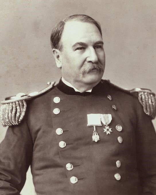 A man in a military uniform with two medals prominently displayed on his chest.