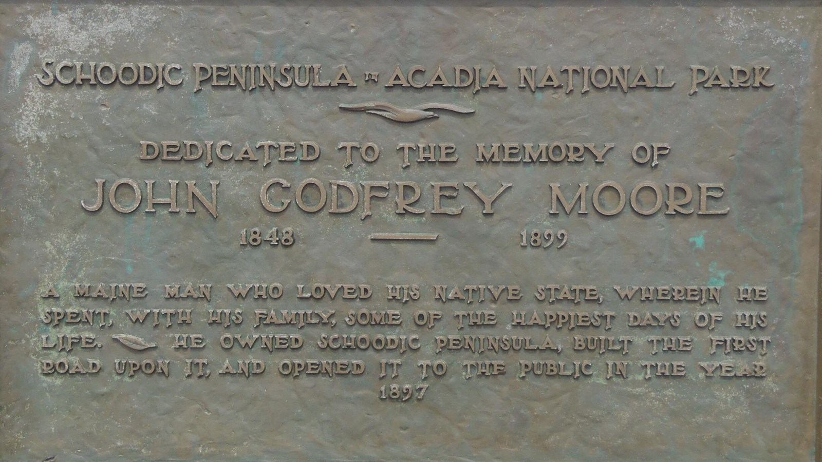 Bronze plaque on granite, inscription dedicated to John Godfrey Moore