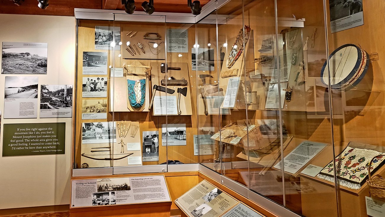 Interior view of a museum display of artifacts in a glass case.
