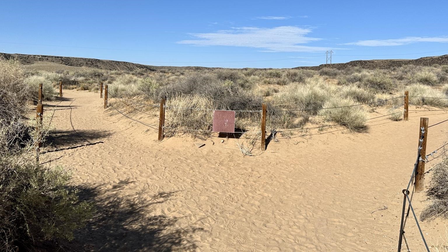 A sandy trail in a volcanic landscape.