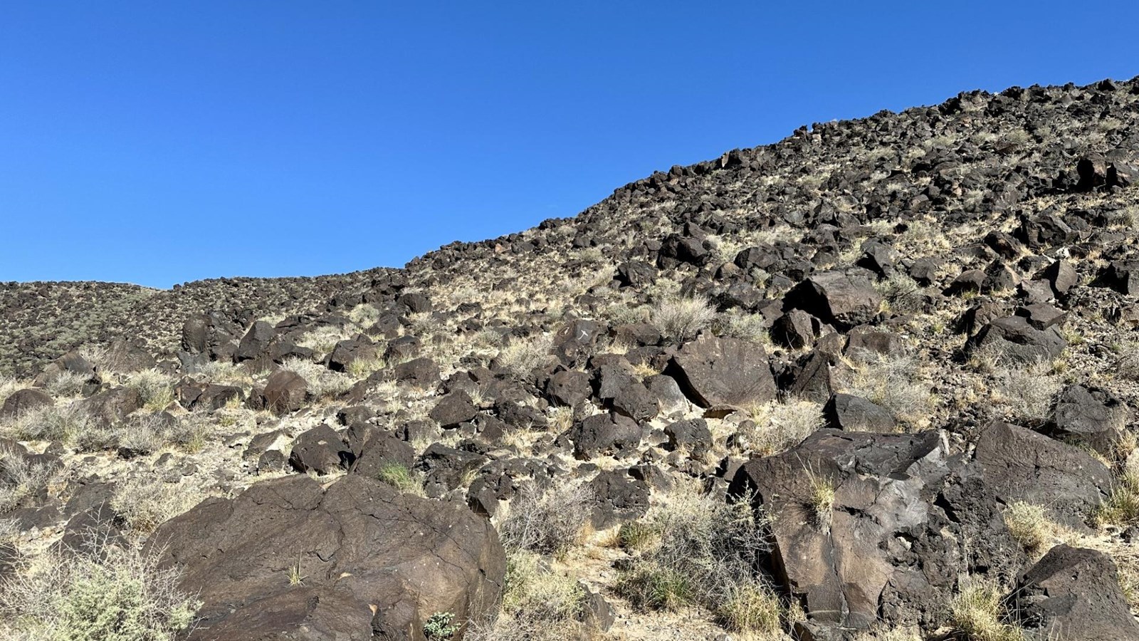 A volcanic landscape under a blue sky.