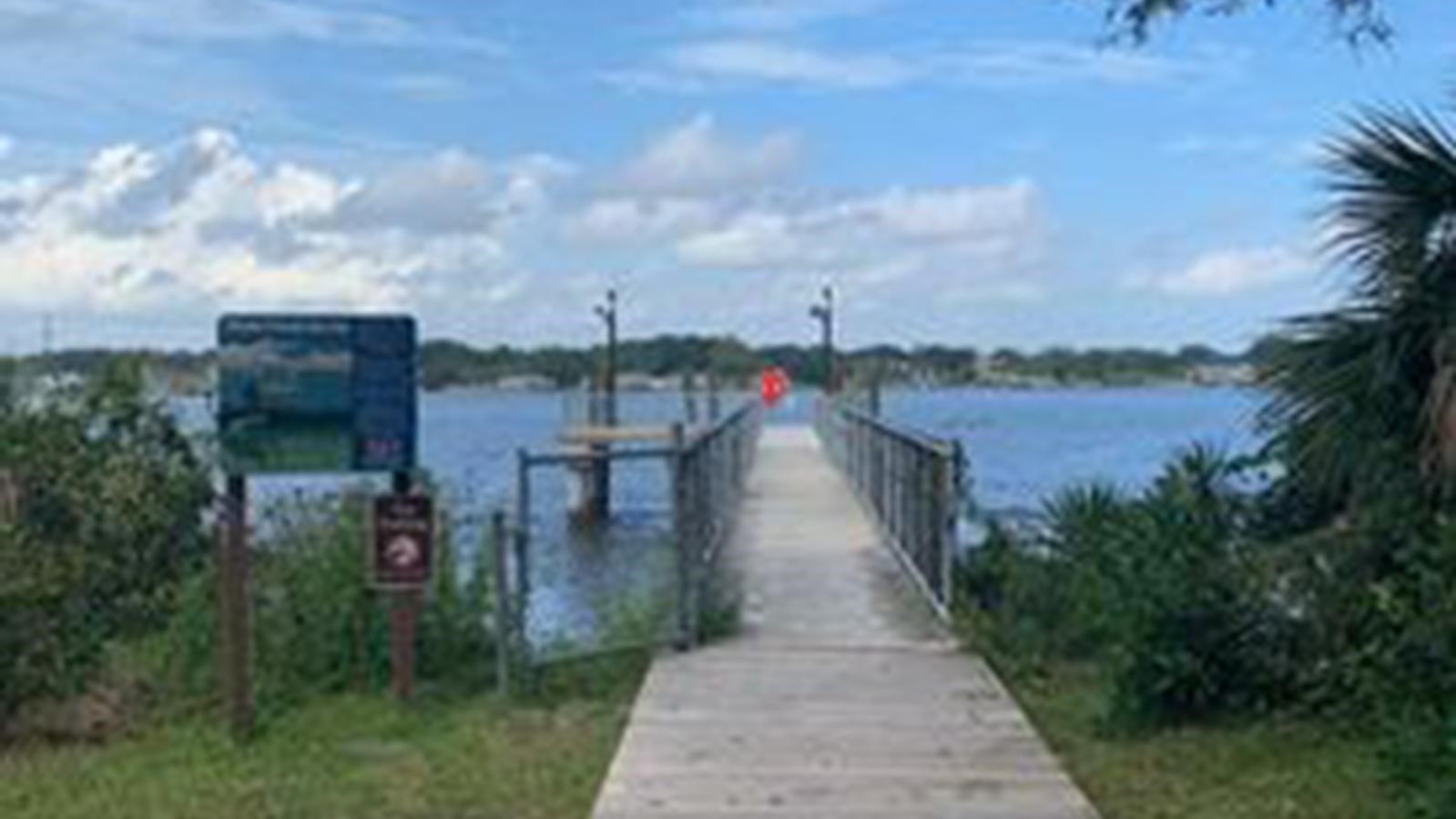 a wooden walk onto a concrete pier 