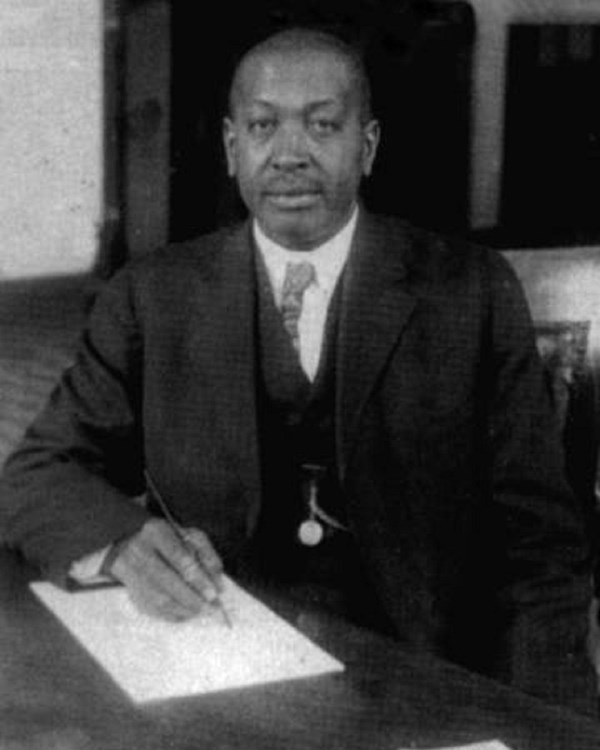 Man in a suit sitting at a desk