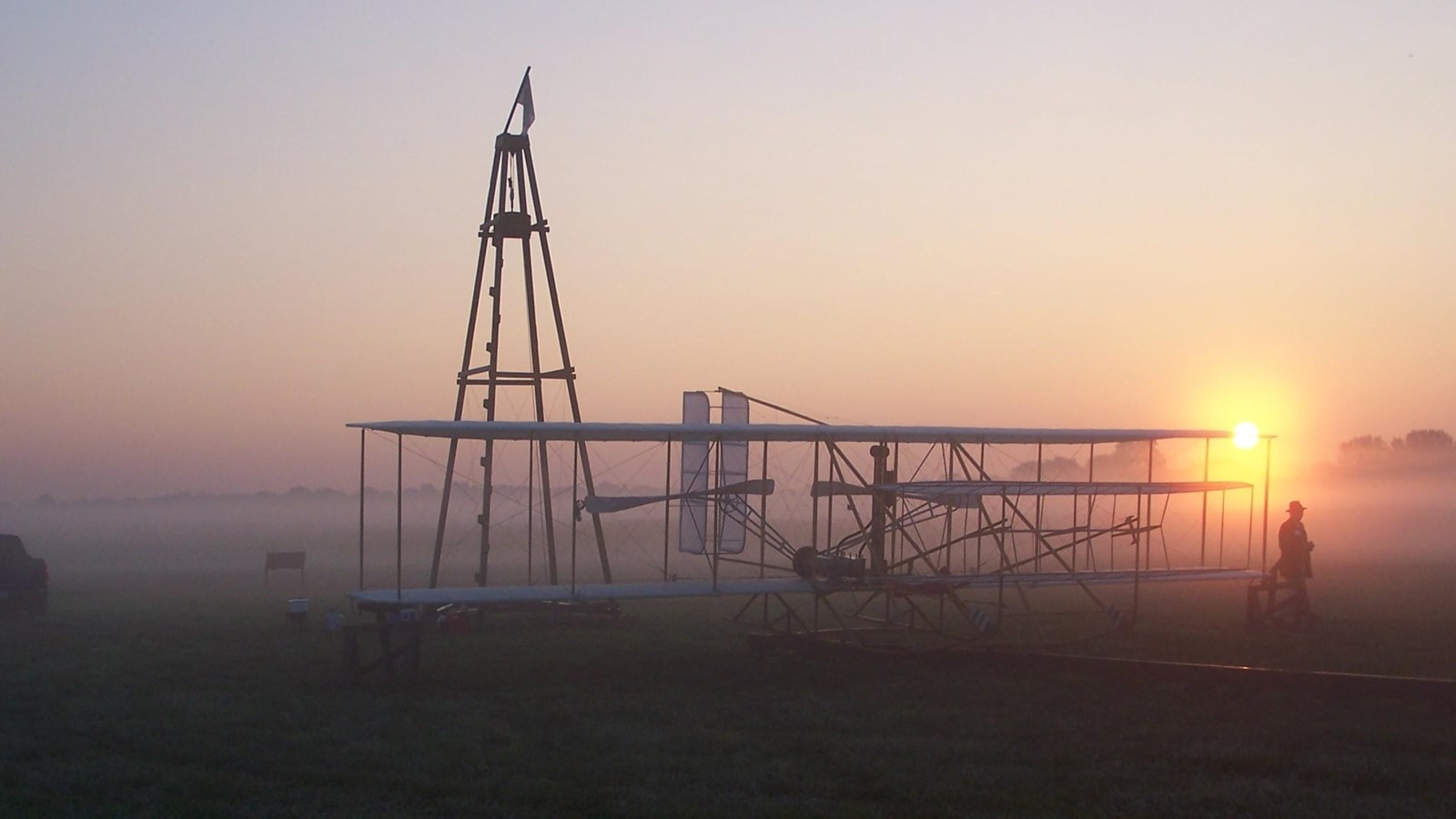 Historic airplane at sunrise  in field