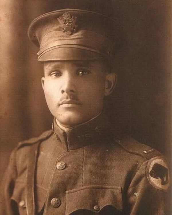 Sepia photograph of African American Man in World War One uniform. Photo is from the chest up