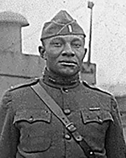 Blakc and white photo of 4 African American army officers in World War 1 uniforms