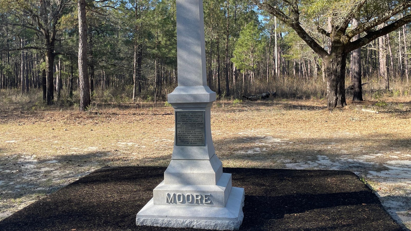 Stone Obelisk Monument sitting alongside a rubberized trail.