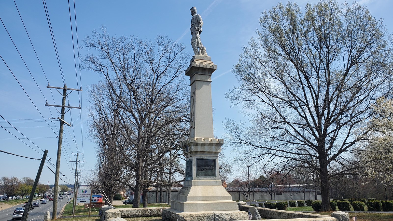 A monument on a stone column topped with a statue of a Civil War soldier.
