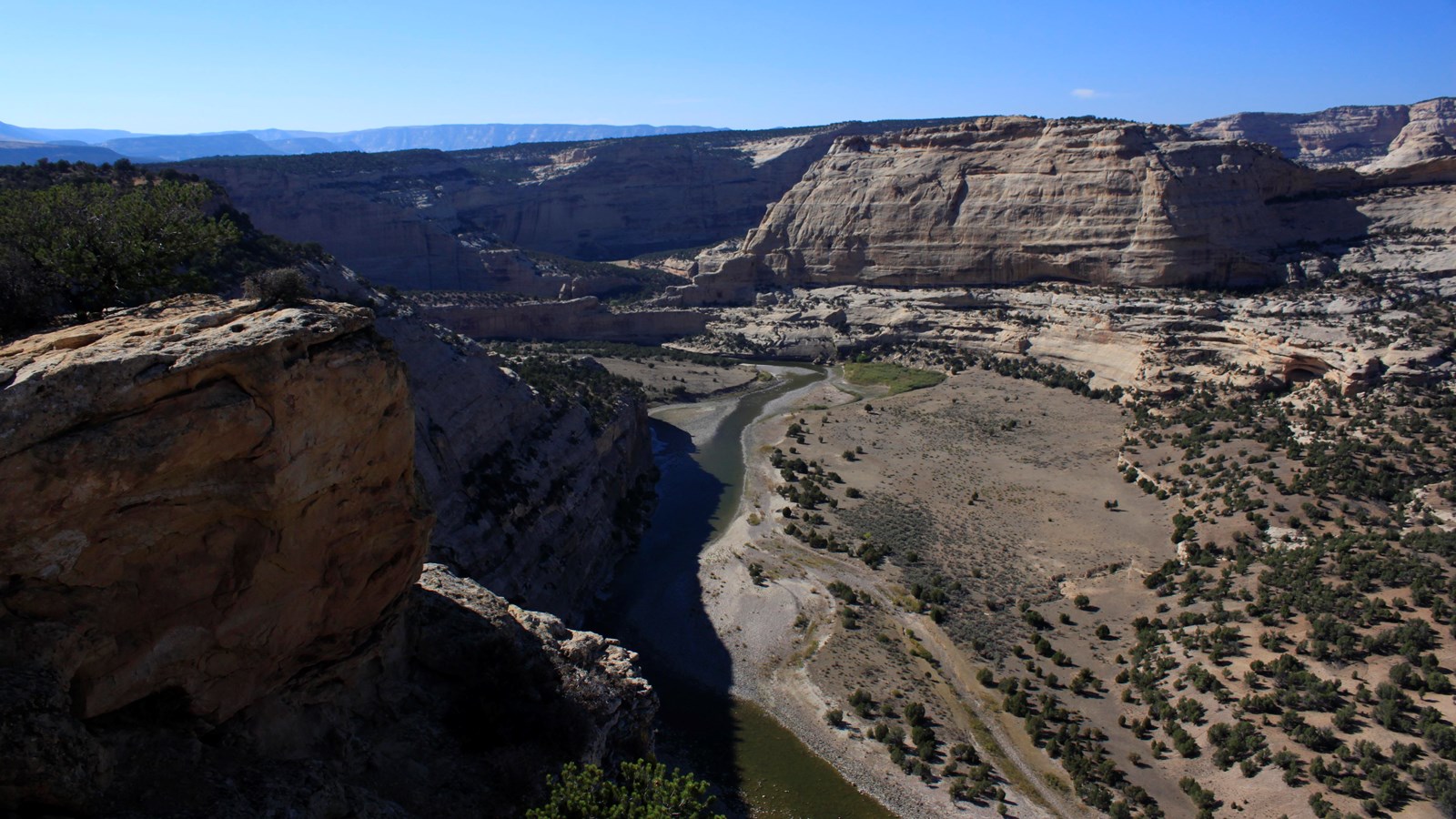 A high vista overlooking a sandstone river canyon.