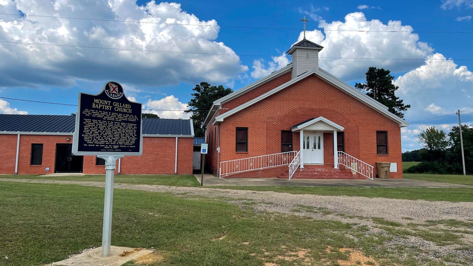 A photo of the Mt. Gillard Missionary Baptist Church with a State Historical Marker.