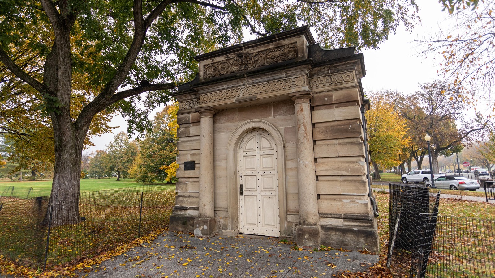 A small stone building with a single door and window.