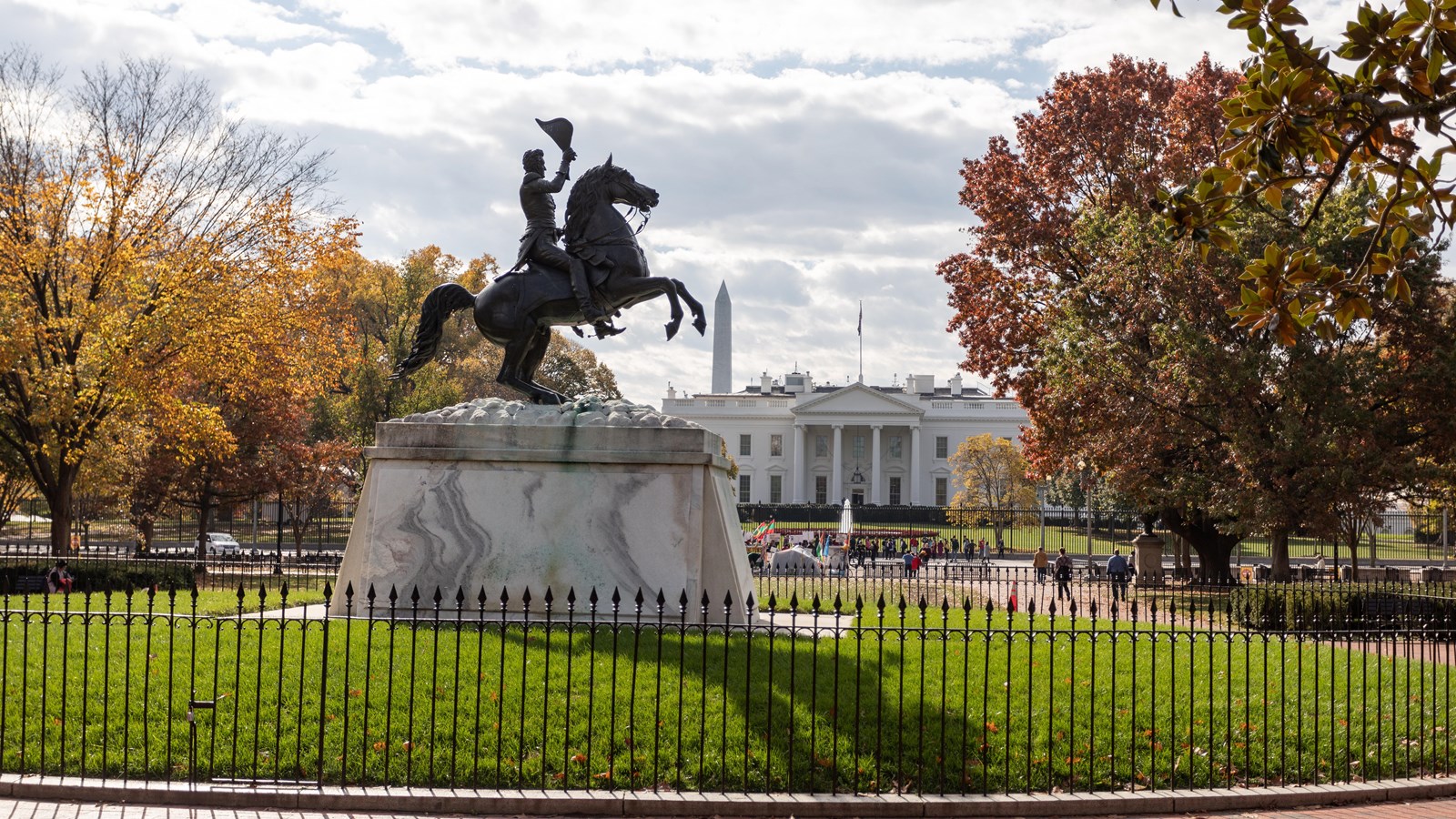 A statue of General Andrew Jackson on a galloping horse waving hat in the air. A canon is nearby.