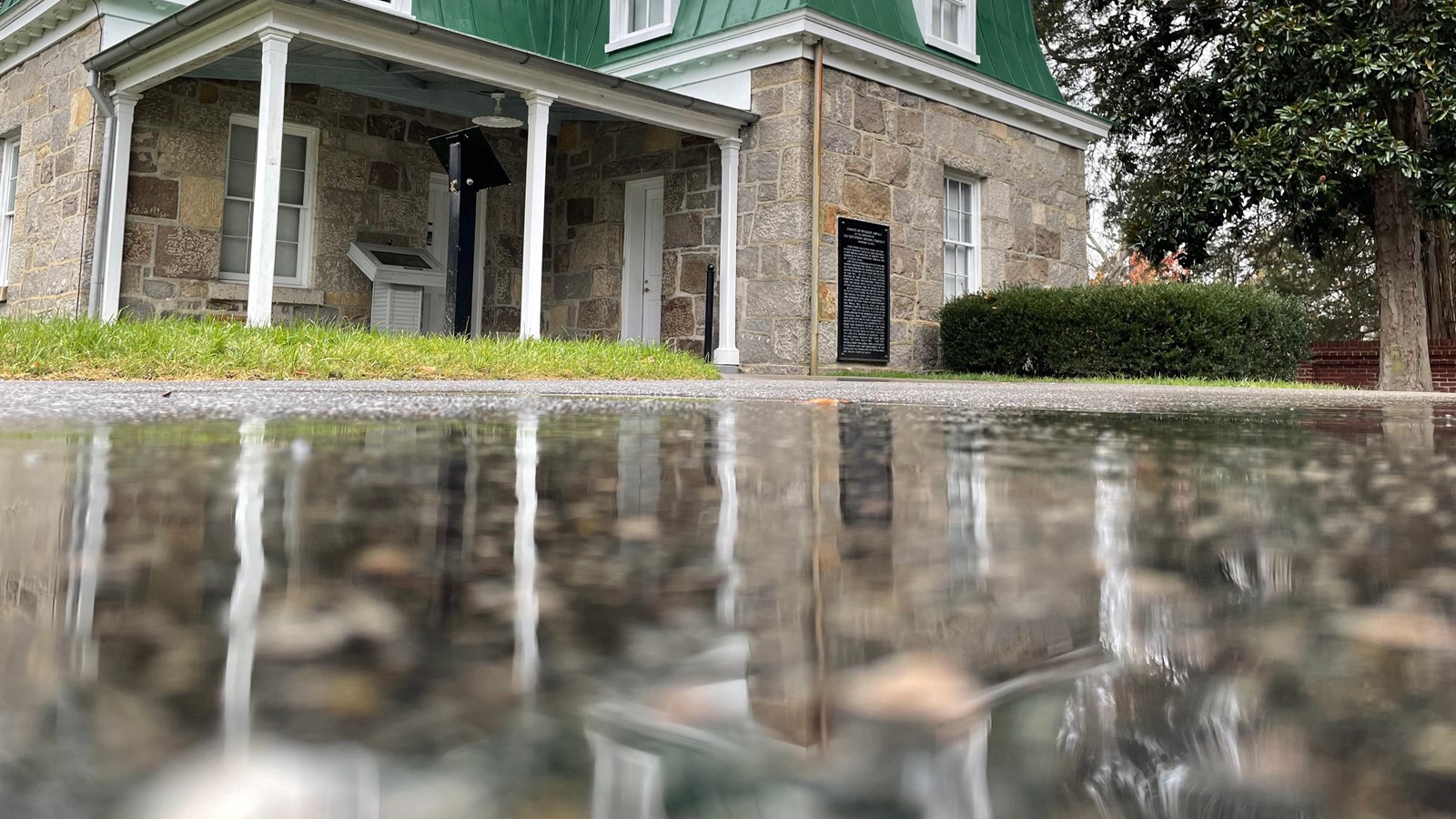 The Superintendent\'s Lodge reflecting in a puddle