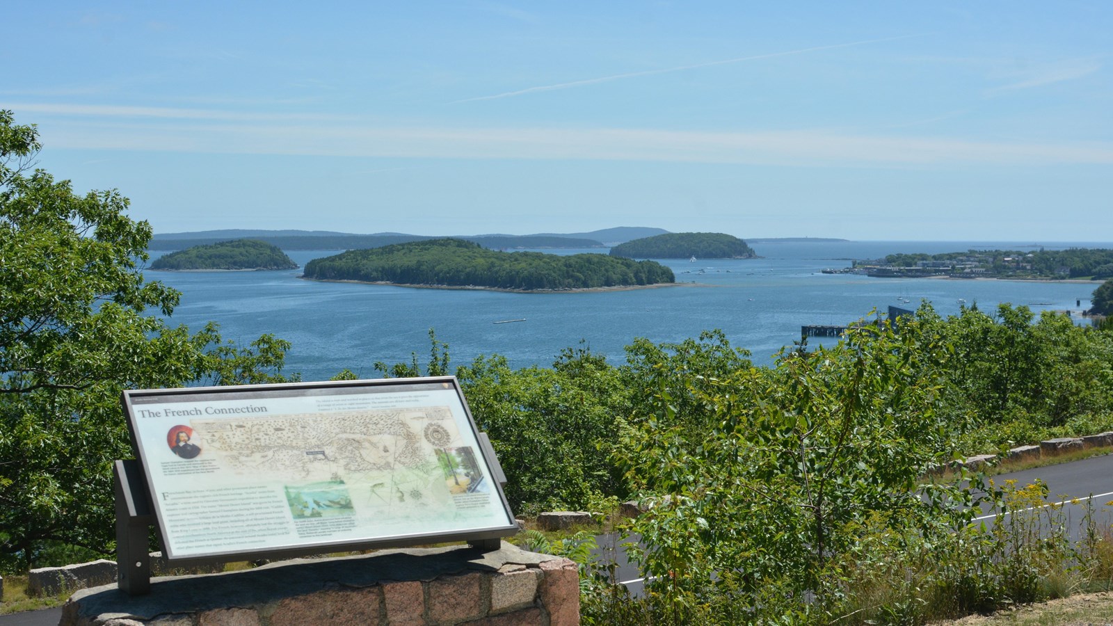 A roadside exhibit with islands in the background