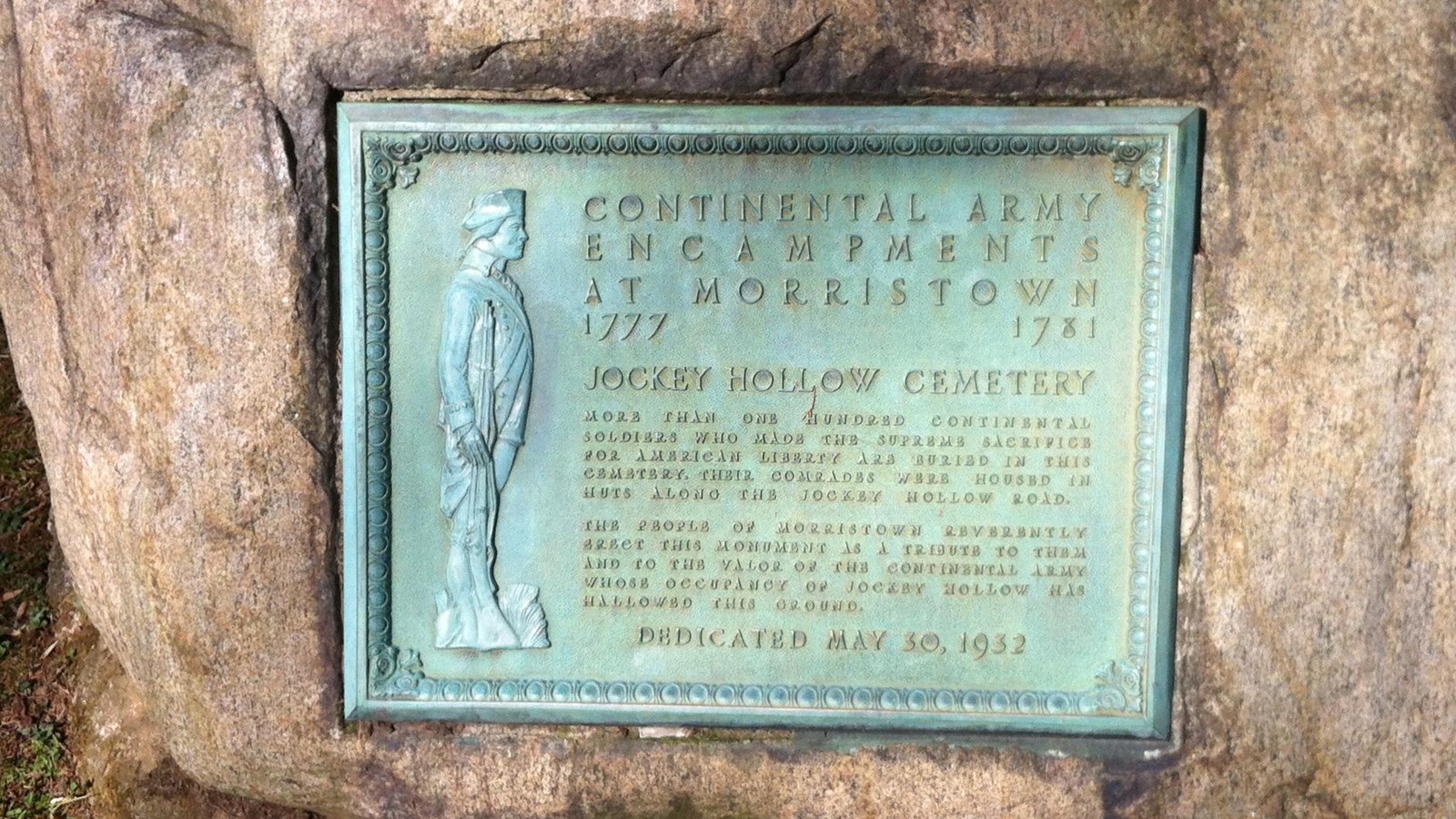 A historic marker set into a rock