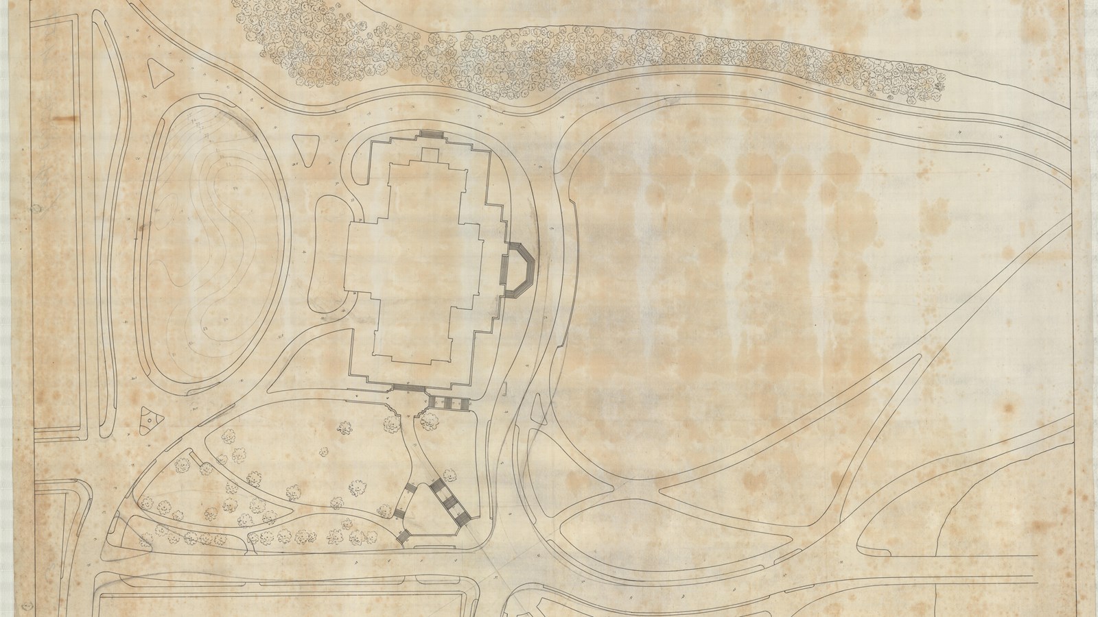 Plan of symmetrical building with curving paths leading to it and open space around it 