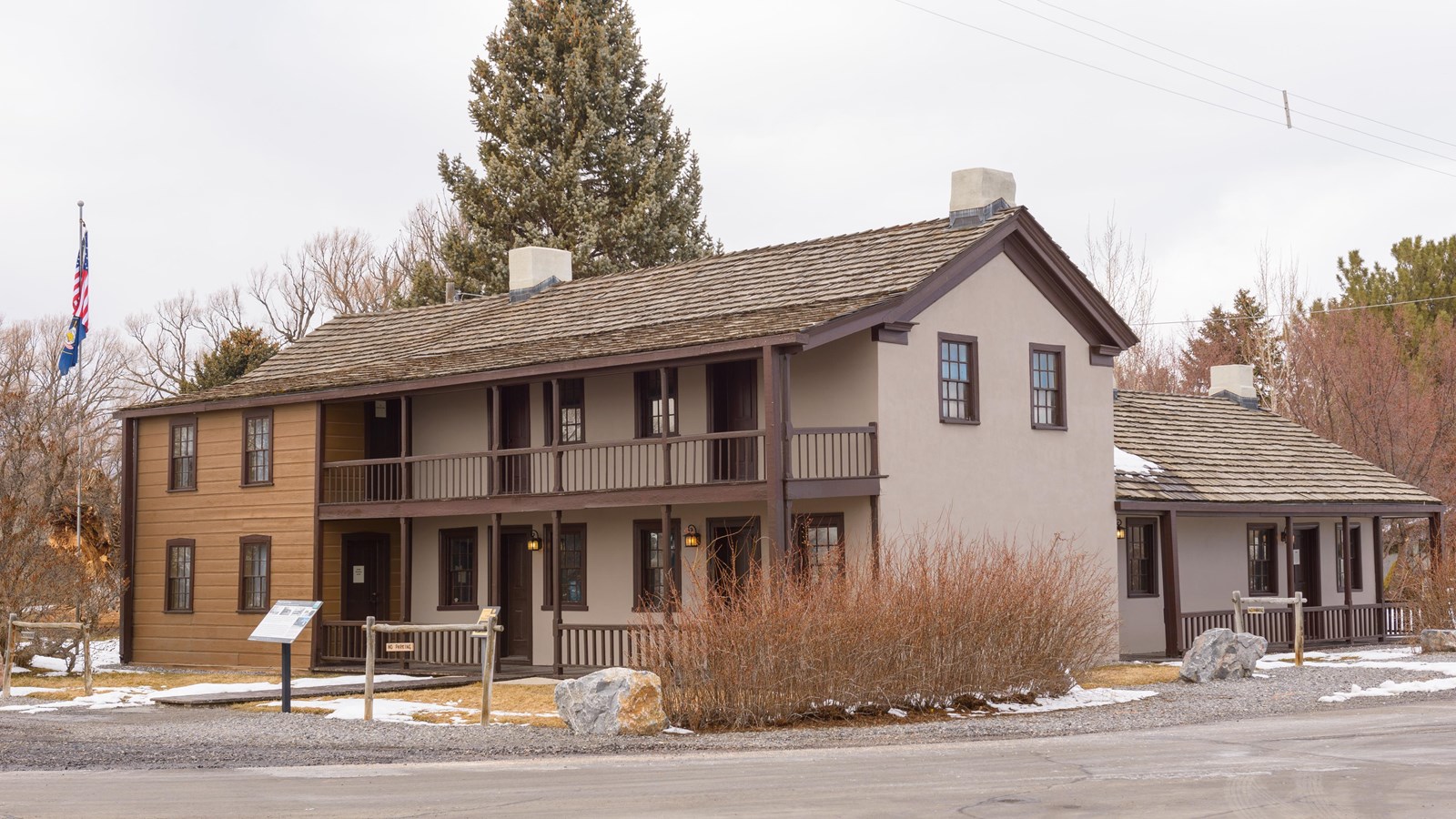 A large, two-story historic home with a large second story balcony.