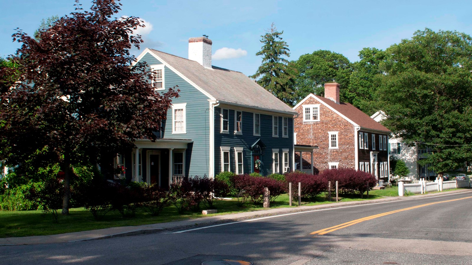 Blue house on the corner of a road