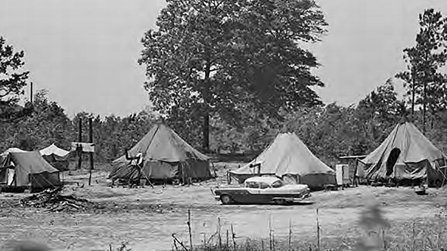 A photo of various canvas tents that were home to evicted farmers.