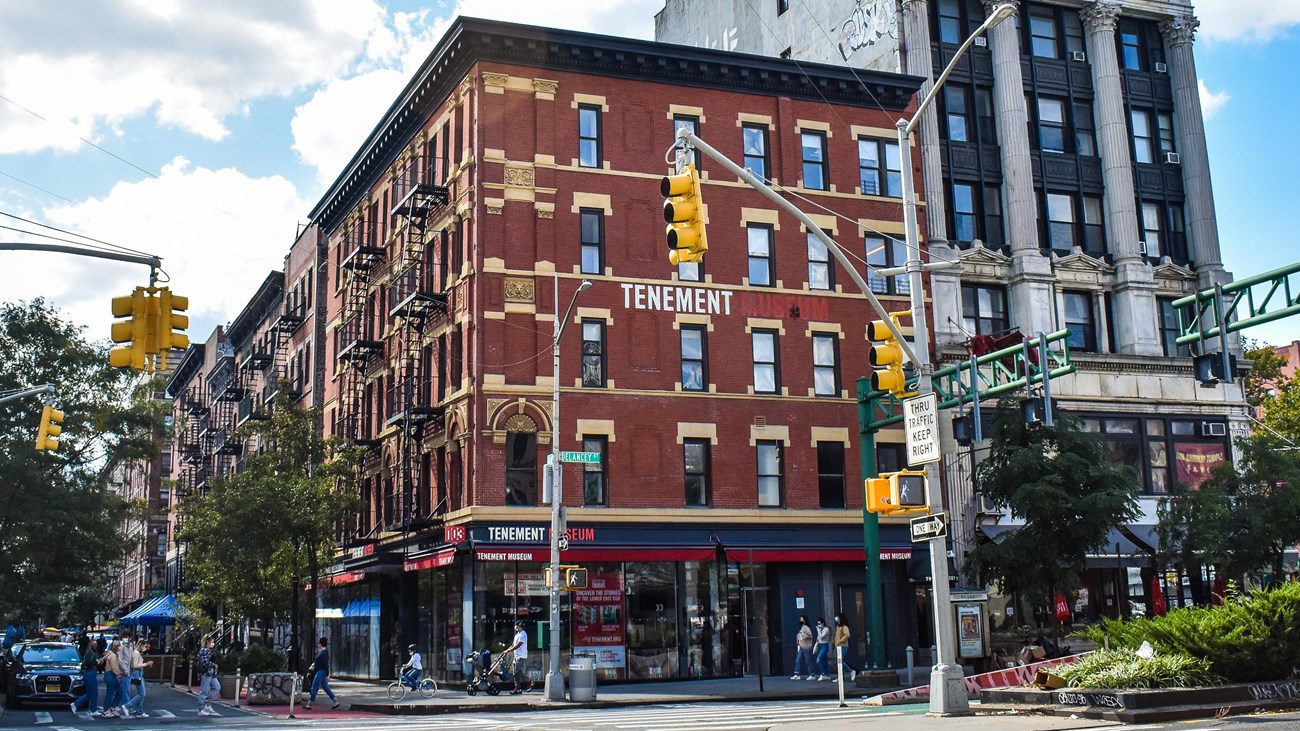 A red brick building against a blue sky with white clouds