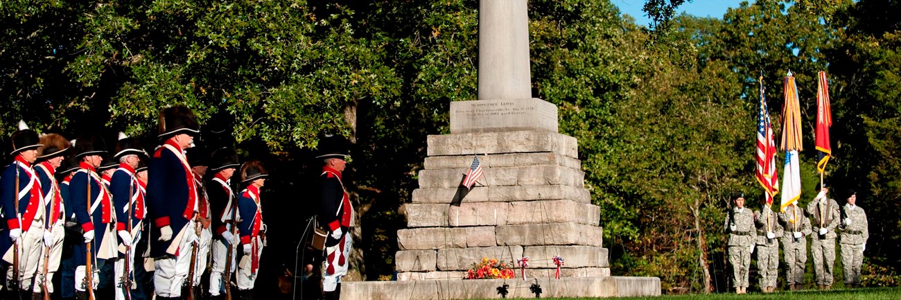 Ceremony honoring the life of Meriwether Lewis with reenactors and Army soldiers.