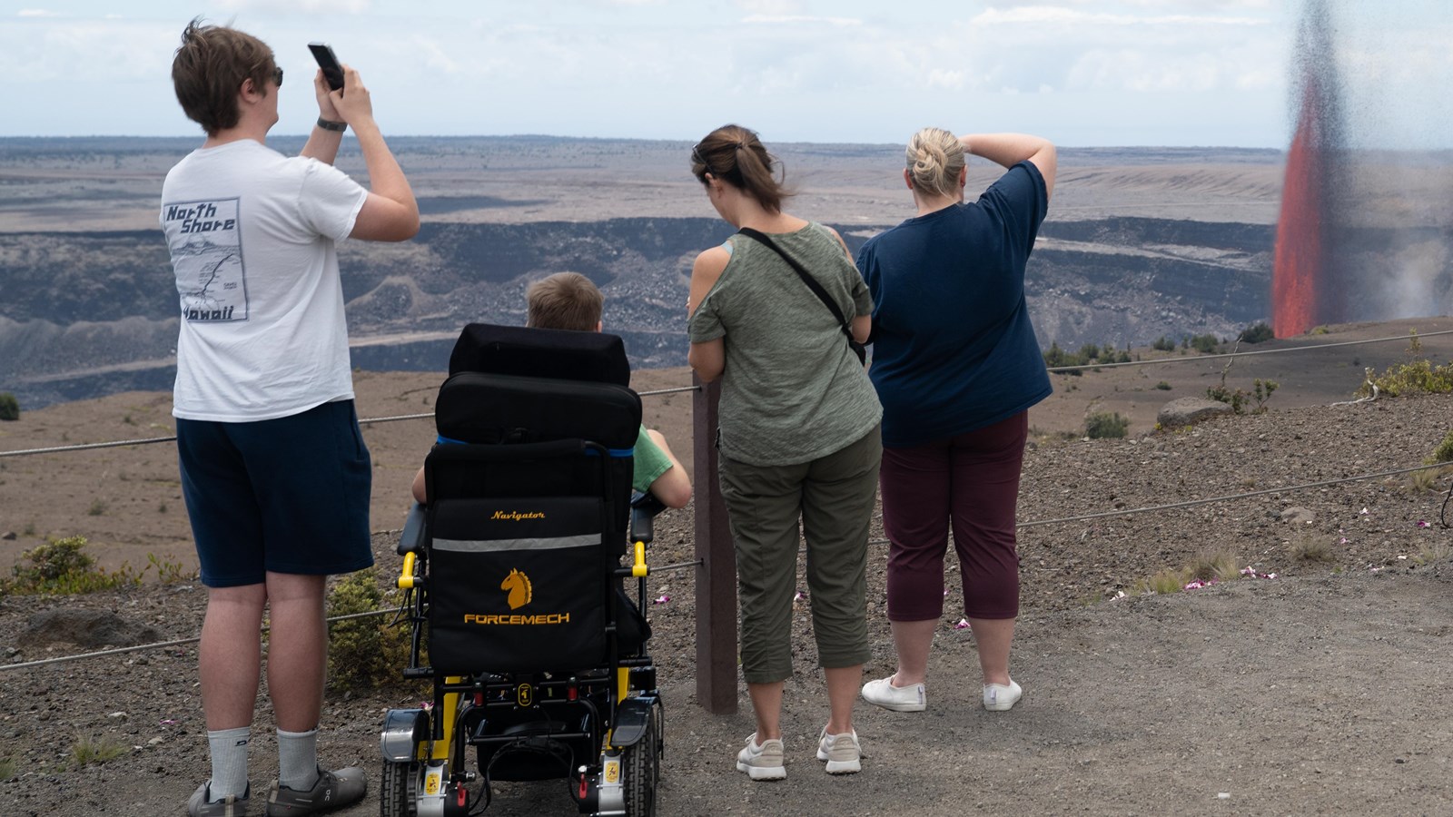 Group of visitors viewing the eruption from the crater\'s edge. 