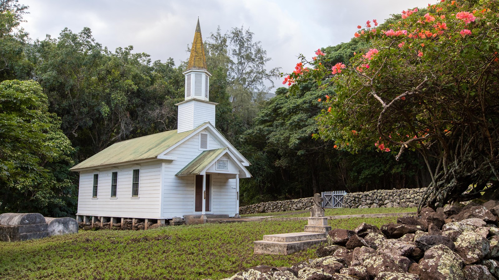 A white church building with a steeple. 
