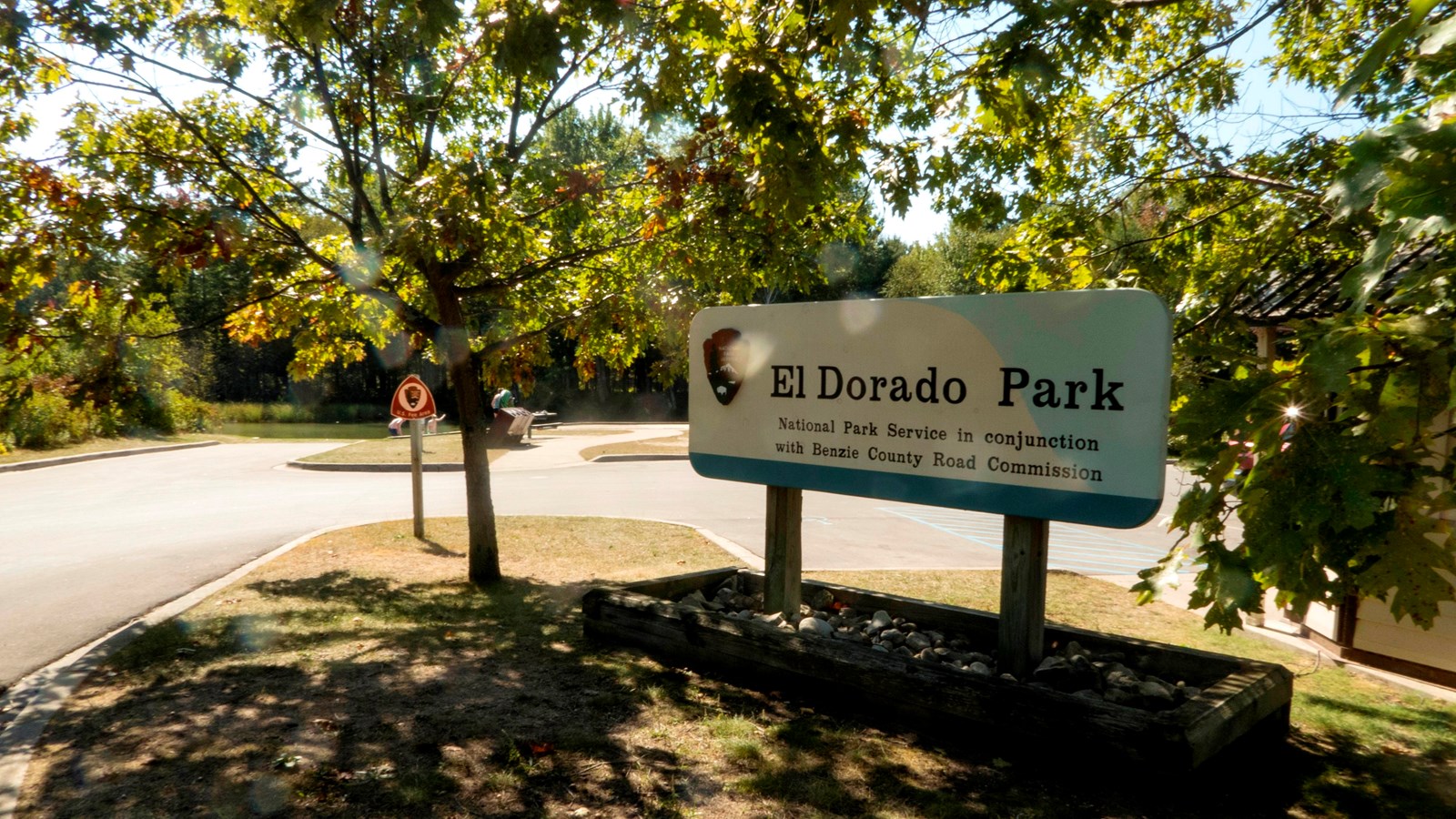 Large wooden sign with the words El Dorado Park in black on an off white and blue background.