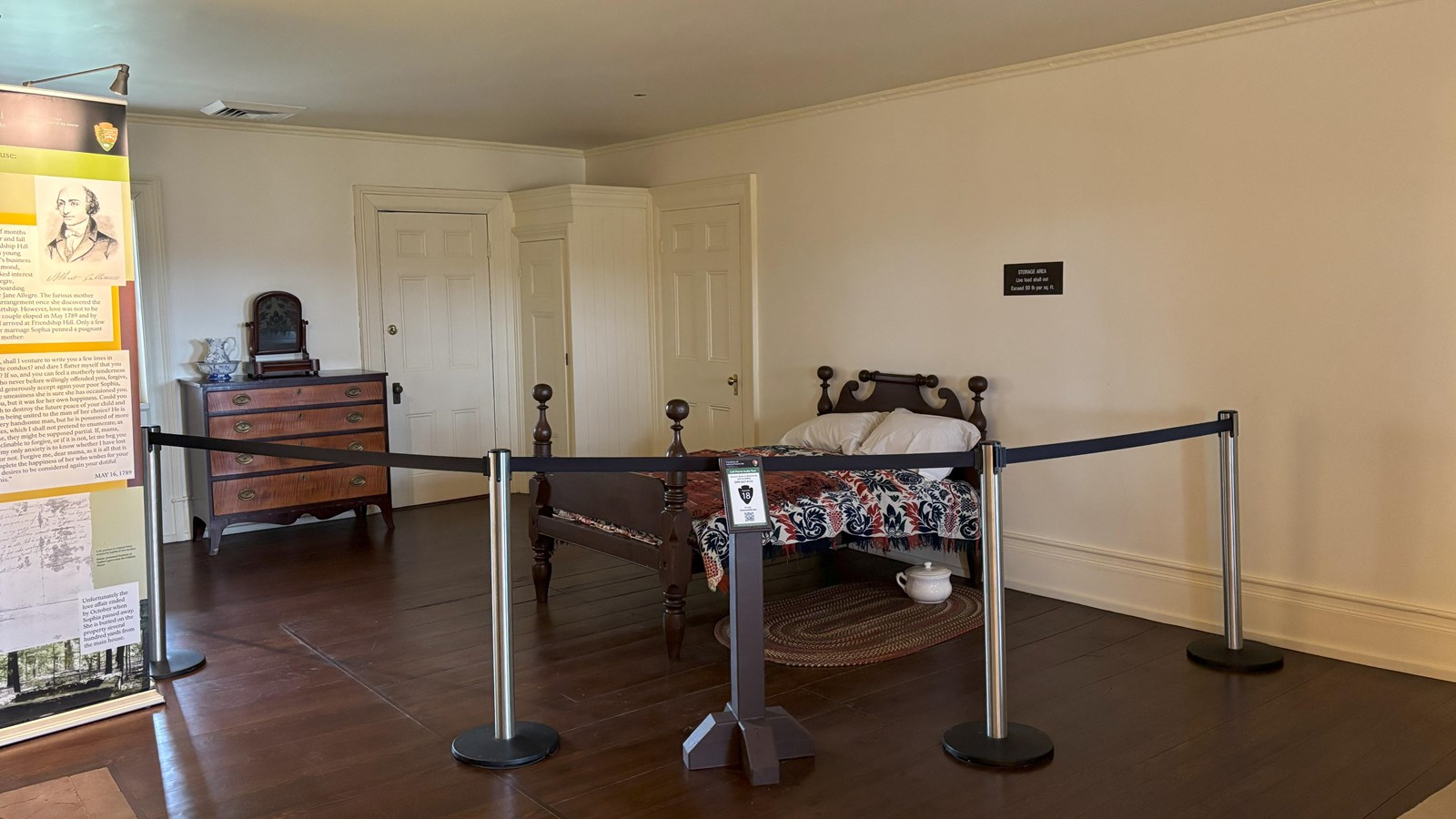 Furnished bedroom with a bed and bureau.