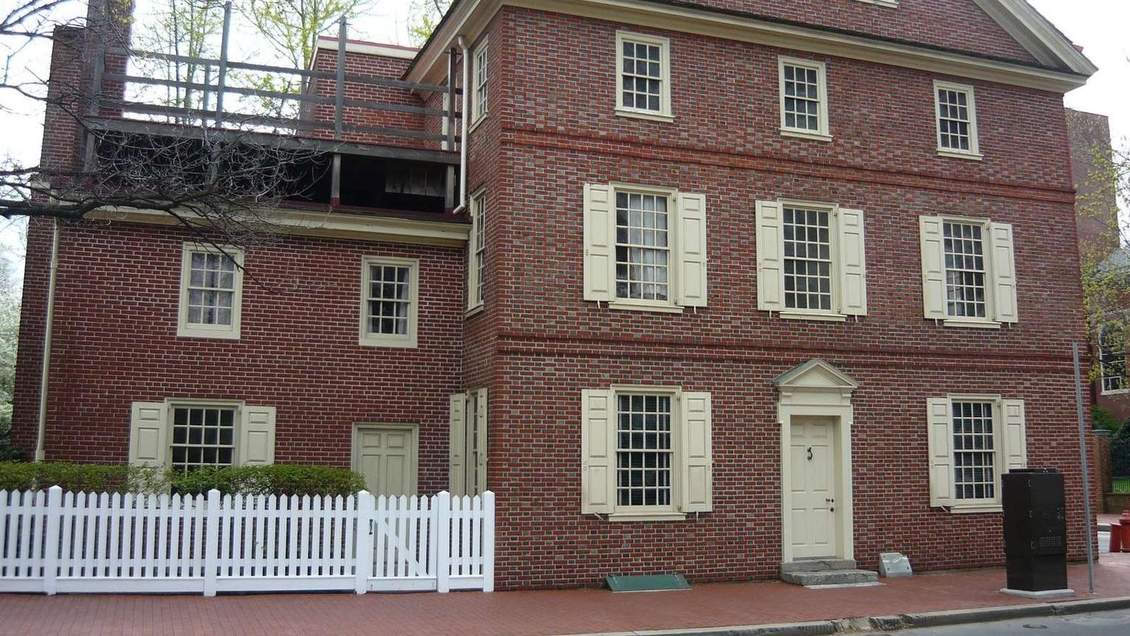 A color photo of the exterior of a red brick rowhouse on the corner of 4th and Walnut Streets.