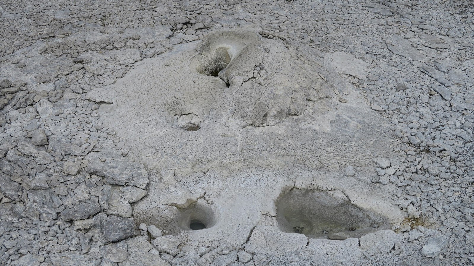 Three small vents located in the sinter in a geyser basin.