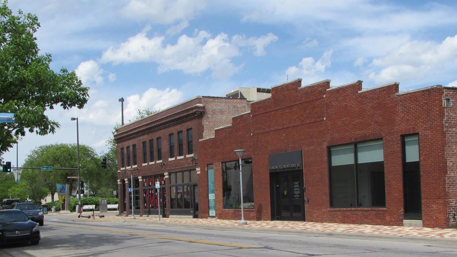 Brick commercial buildings along North 24th Street. Two story building and single story with parapet