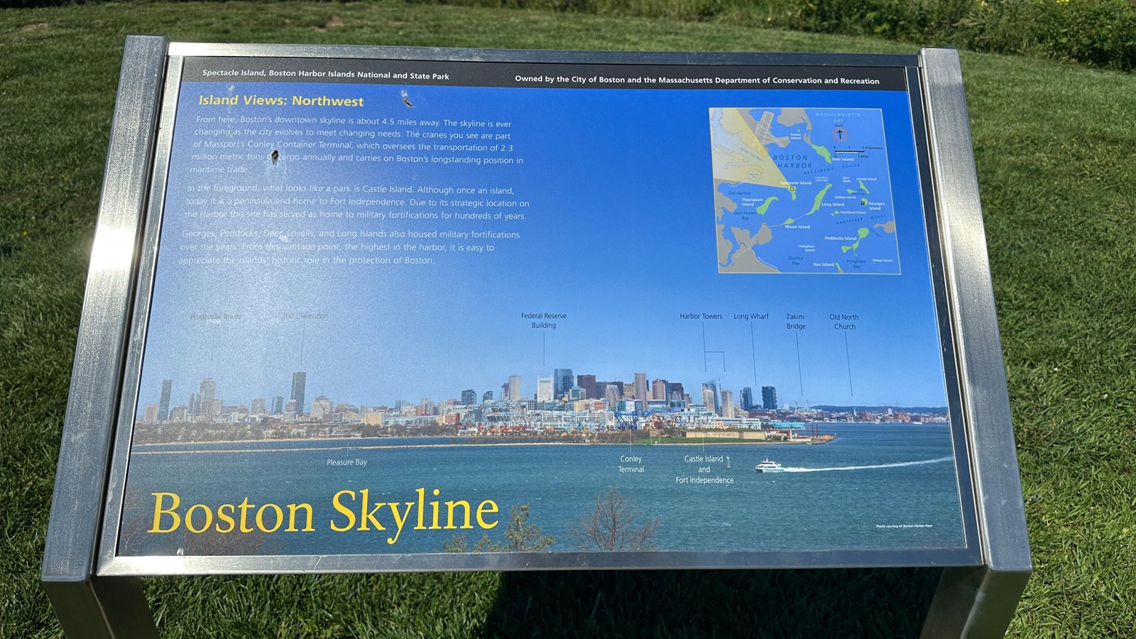 Image of a metal wayside with a photo of the Boston skyline and a column of text