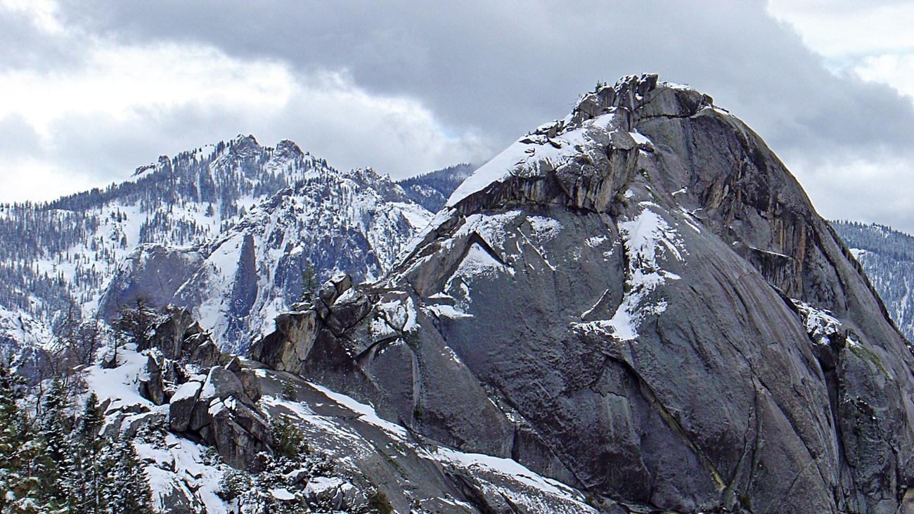 Snowy conditions on a large granite dome.
