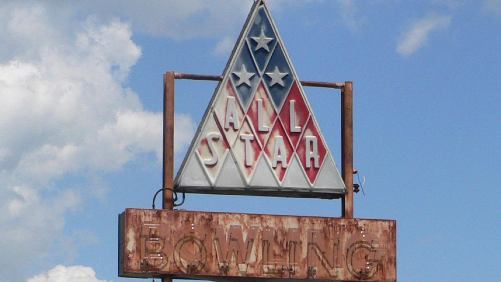 Faded sign of All Star Bowling Lane. 