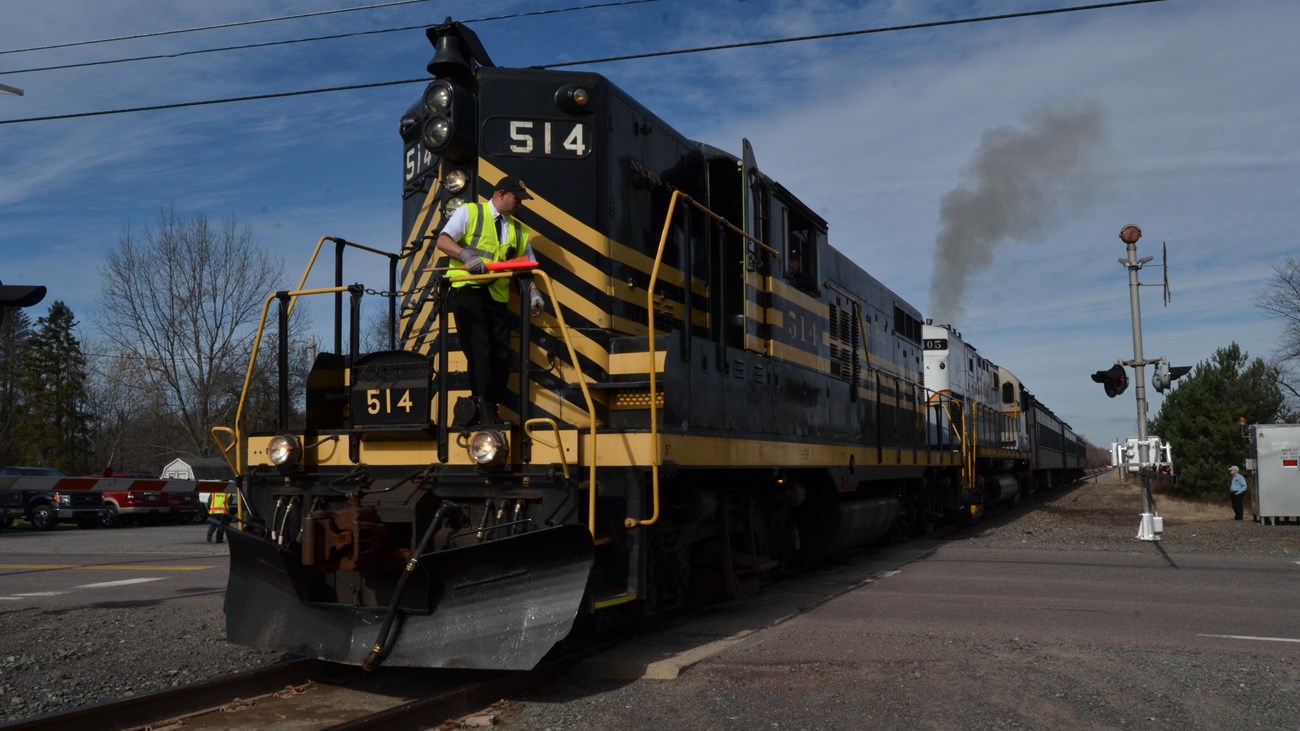 Diesel locomotive number 514 at a road crossing