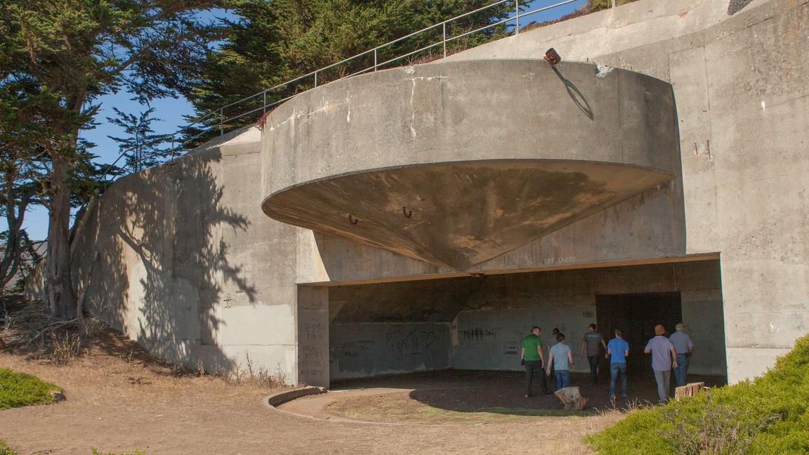 Visitors under the Battery Wallace concrete parapet.