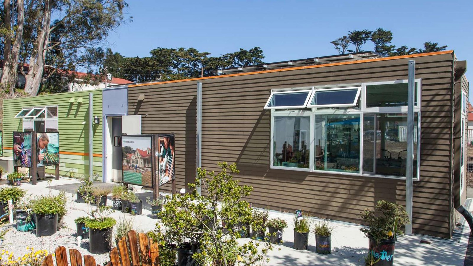 Rows of potted plants sit in gravel outside of the Presidio Nursery.