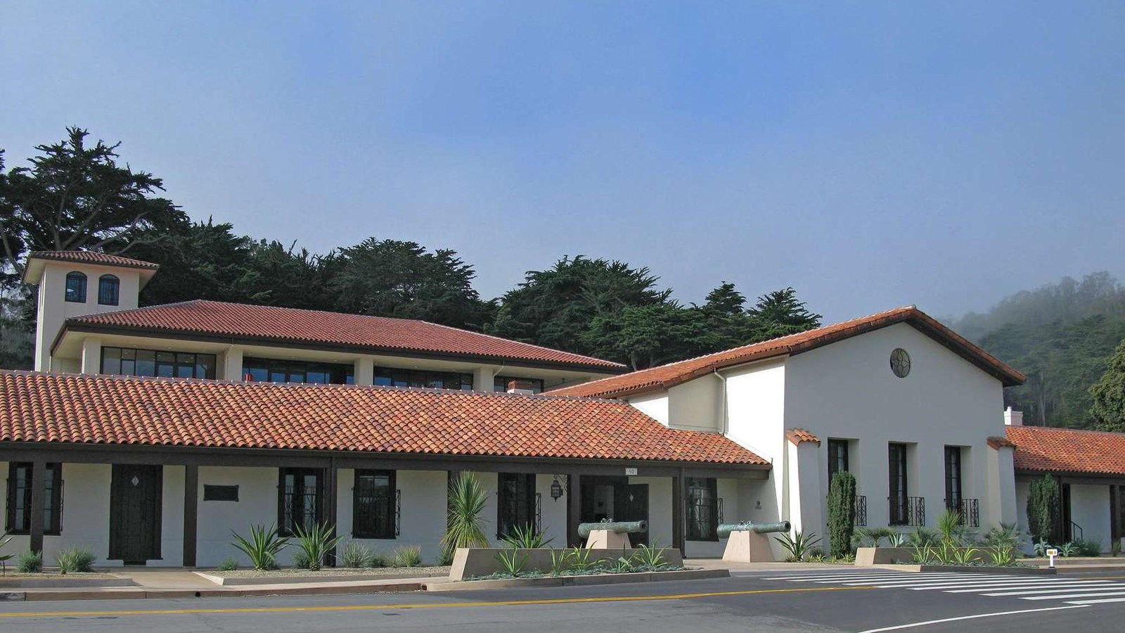 View of the white stucco, red roofed Presidio Officers\' Club as it looks today.
