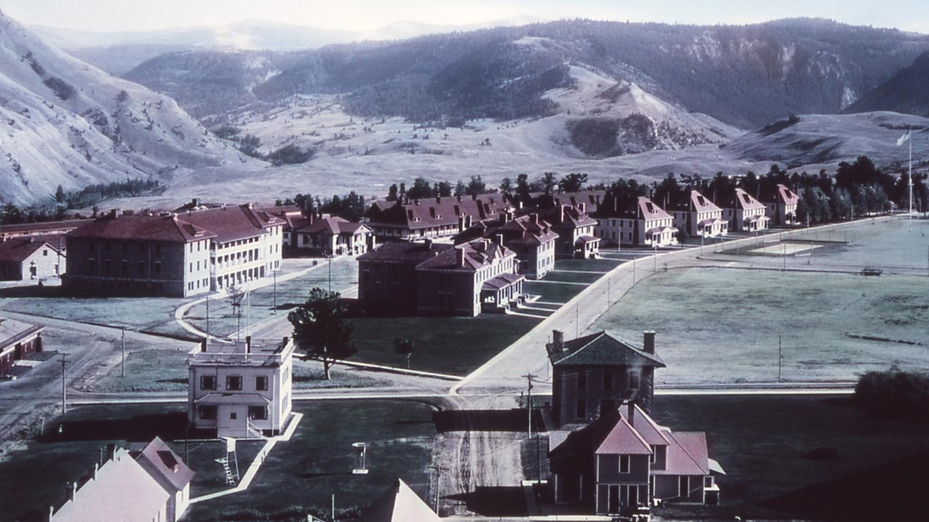 A historic photo of a collection of buildings that make up Fort Yellowstone.