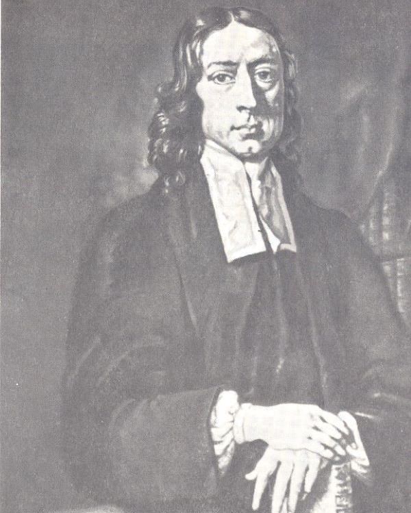 Portrait of a man with long hair and a clerical collar. 