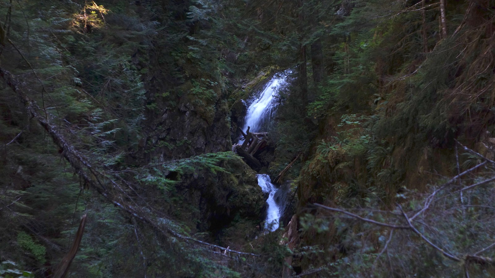 Two-tiered waterfall in a narrow canyon