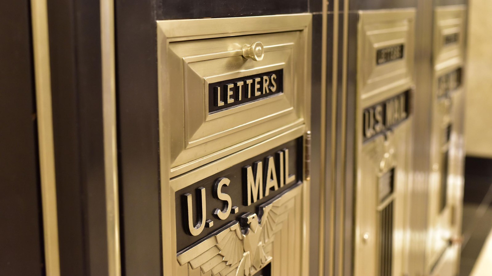 A close up of vintage post office mail boxes