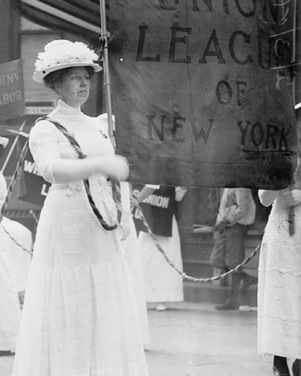 Margaret Hinchey leads a group of women carrying pro-labor banners