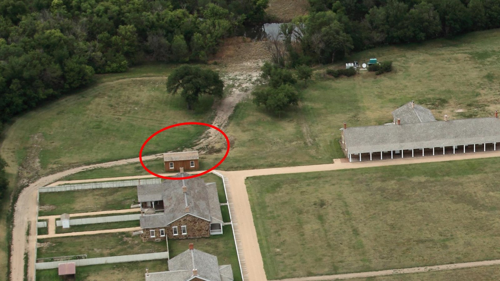 Aerial view focused on the north end of Officers\' Row with the Adjutant\'s Office circled in red.