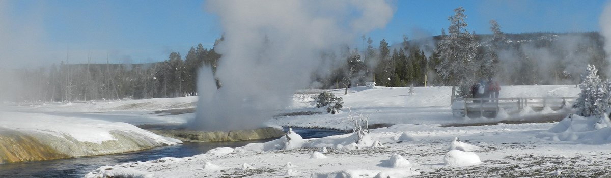 Black Sand Basin thermal features billowing steam along the Firehole River on a cold winter day.