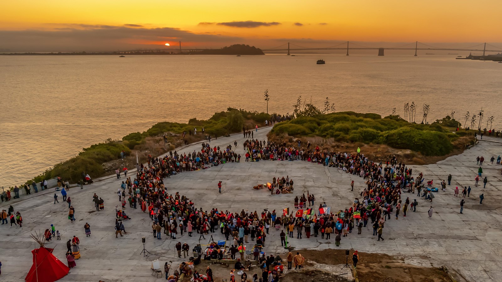 Colored photograph. An aerial view of the gathering for a sunrise ceremony held on the parade ground
