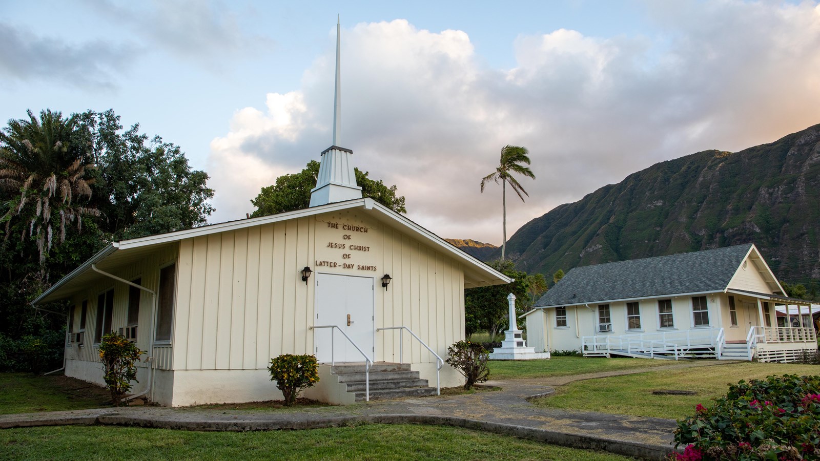 An off-white building with a steeple and the sign, The Church of Jesus Christ of Latter-Day Saints