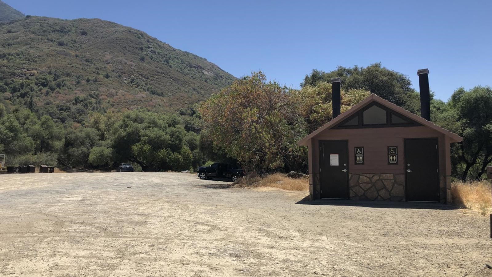 A small building and dirt parking lot at Potwisha Day Use Area